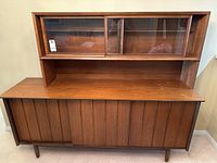 Straight-on front view of the full credenza base and upper glass cabinet