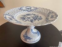 Front angle view of the Meissen Blue Onion pedestal cake plate showing overall design and height.