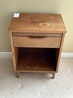 Front view of the solid wood end table showing single drawer and open storage shelf below.