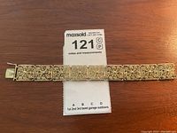 Full view of the vintage silver filigree bracelet laid flat showing multiple ornate square links and clasp.