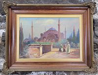 Full view of the framed oil painting showing Middle Eastern mosque, minarets, and figures on a pathway.