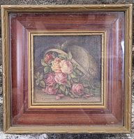 Framed small square oil painting on board showing floral basket of roses.