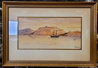 Framed watercolor painting showing a coastal scene with a ship and hills with buildings.