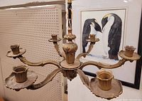 Front and side view of vintage heavy brass chandelier suspended and showing six arm candle holder cups with ornate detailing.
