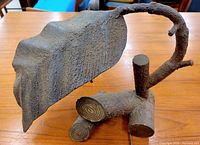 Close-up of the metal leaf shaped lamp shade and base made to look like a tree branch.