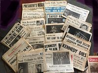 Photo showing various historic newspapers from 1963-1969 related to JFK and RFK assassinations and Apollo launch