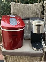 Overall shot showing EuHomy red ice maker and Keurig coffee maker side by side on chair