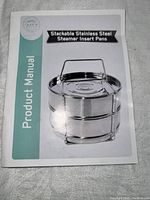 Product manual for stackable stainless steel steamer insert pans showing the product in use with a handle on top