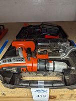 Full kit view showing Black & Decker Firestorm cordless drill, carrying case, two batteries, and drill bits.