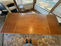 Top-down view of table fully extended with both leaves open