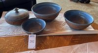 Full set of 4 earthenware items shown on wood table: 3 mixing bowls and 1 lidded casserole dish in matching pattern and color.
