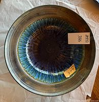 Top view of glazed bowl showing color gradient from dark blue in center to lighter blue and green hues near rim