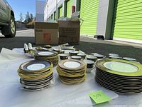 Full set arranged on ground showing all plates, cups and serving pieces