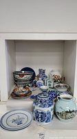 Full lot overview on shelf with plates, bowls, jars and vases