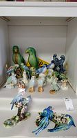 Overall view of all ceramic bird figurines arranged on shelf