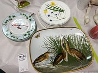 Front view of Portmeirion Welsh Wild Flowers plates and bird-themed platter