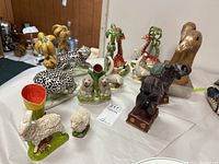 Group of all eight Staffordshire-style animal figurines on table