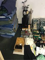 Overview of golf bag, clubs and accessories placed against wall