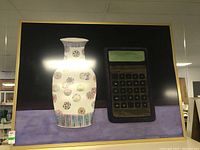 Full view of framed painting showing vase and calculator