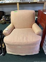 Front view of armchair showing upholstery and overall condition