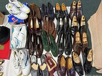 Overhead view of all 11 pairs of men’s shoes including sneakers, boots, dress shoes, loafers and slippers