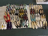 Overall view of 32 pairs of women’s shoes arranged on sheets