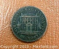 Obverse of the token showing a building with inscription Province of Canada Bank of Montreal.