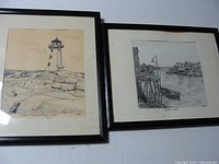 Two framed pencil drawings photographed together on a white surface, showing their overall condition and framing.