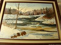 Full view of framed landscape oil painting showing winter river scene with trees and snow, signed Eric