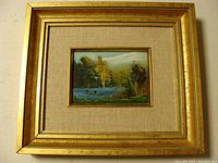 Overall view of the framed oil painting showing the golden frame and beige mat surrounding the artwork.