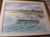 Full view of framed seascape painting showing two boats on water near shoreline signed by D. Sanderson.