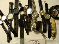 Overview image showing all twelve watches in the lot with various band styles and dial types.