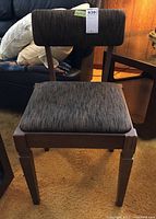 Full front view of the wood framed chair showing upholstered seat and backrest