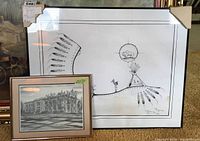 Photo showing two framed prints: left is Limited Edition Indigenous Art print with some staining, right is framed Hamilton Public Library print.