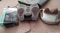 TherapistSelect Deluxe adjustable shiatsu massager, Beautiko Body TLC foot massager, and original packaging for Body TLC foot massager