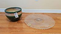 View of the planter pot and cut glass platter side by side on wooden floor, showing relative size and condition.