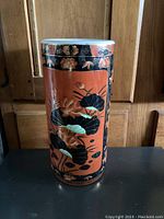 Front and side view of tall Chinese vase with orange and black floral design