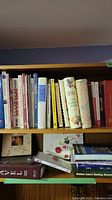 Photo showing a variety of cookbooks and health-related books on garden plants and diabetic meals arranged on shelves.