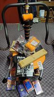 Photo showing ab twister exercise equipment with foam handles and multiple DVDs and guides spread on the floor.