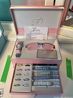 Open display box showing the complete Fondini ladies interchangeable watch set including watch, multiple bezels, bands, and sunglasses.
