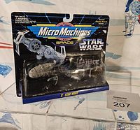 Photo of sealed Micro Machines Star Wars Rebel Transport set in original blister packaging, showing front with included vehicles and character stand.