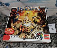 Photo of the closed original box for Lego 3843 Ramses Pyramid board game showing artwork and age indication.