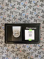 Closed black Sentry Safe shows front with key lock and branded logo on the upper right corner.