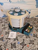 Star Trek Transporter toy showing top and side control panel with colorful buttons, bulbs visible on top.