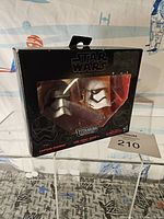 Front view of sealed Star Wars Titanium Series packaging containing Captain Phasma and First Order Stormtrooper helmets.