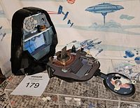 Full view of the Darth Vader helmet playset opened showing interior and figures placed on the platform and a round side platform with additional figures.