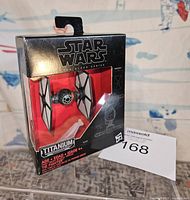 Front view of the Star Wars Titanium 04 TIE Fighter boxed figure showing packaging condition and figure visibility.