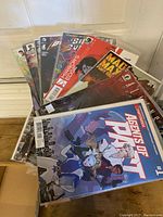 Collection of comics laid out showing various titles and variant covers including 'Agents of Pratt', 'Mad Max Fury Road'.
