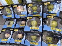 Photo showing 14 boxed Dorbz vinyl figures from Batman series in stacked arrangement, visible characters include multiple Batman figures, Ratman, Penguin.