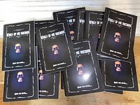 Fifteen black-covered Vault of the Macabre books spread out with a skull on the cover.